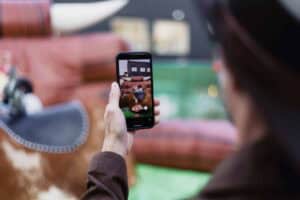 Photo d'une personne prenant une photo avec un smartphone dans un bureau contemporain.
